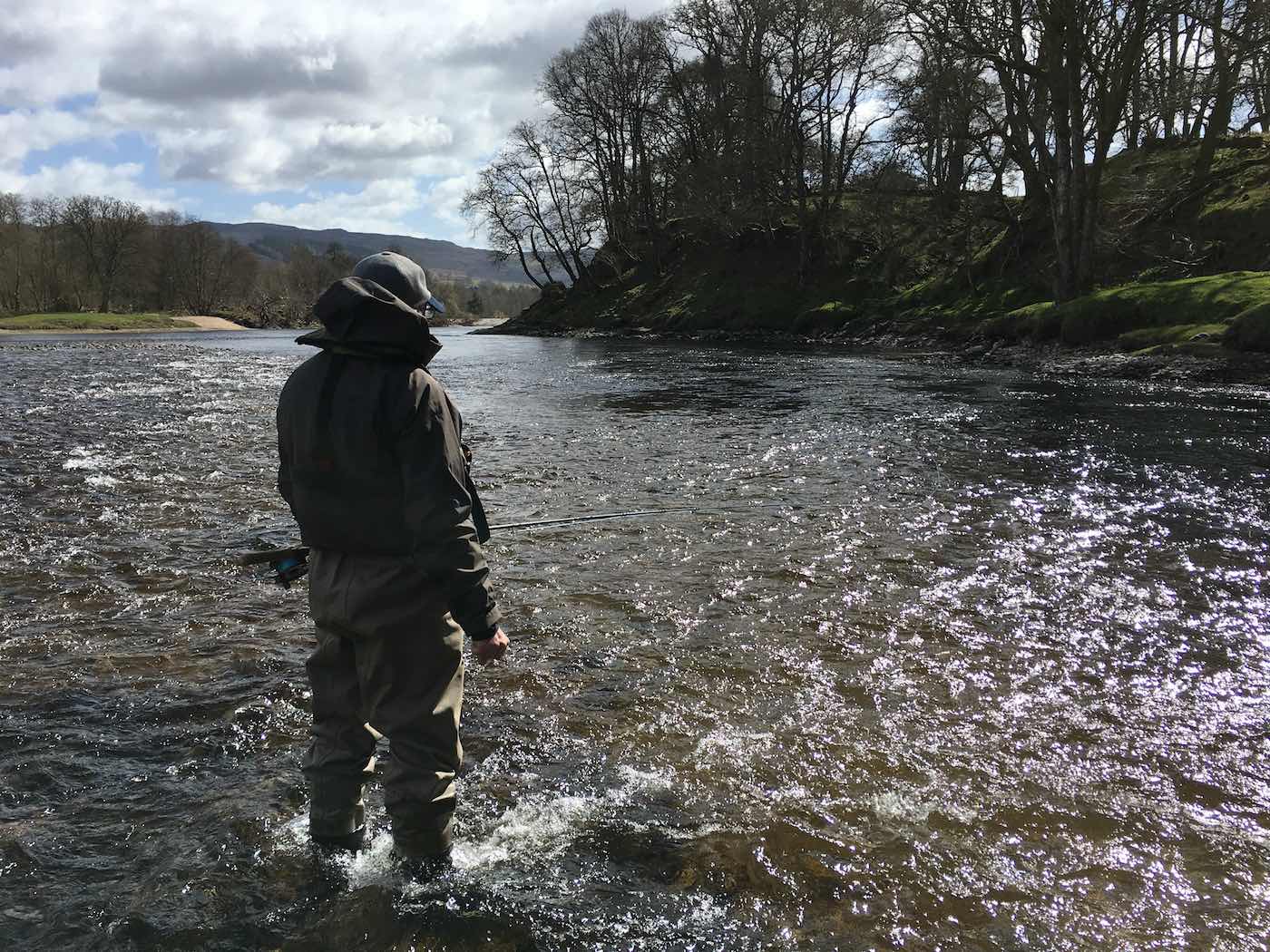 I took this fine photograph of this visiting River Tay salmon fishing trip guest at the neck of the Kinnaird Beat's Rock Pool while working as the fisher's personal salmon fishing guide. The deep shadowy water you can see is the main salmon holding area but it's best fished over from this shallow riverbed stream for maximum stealth of approach.