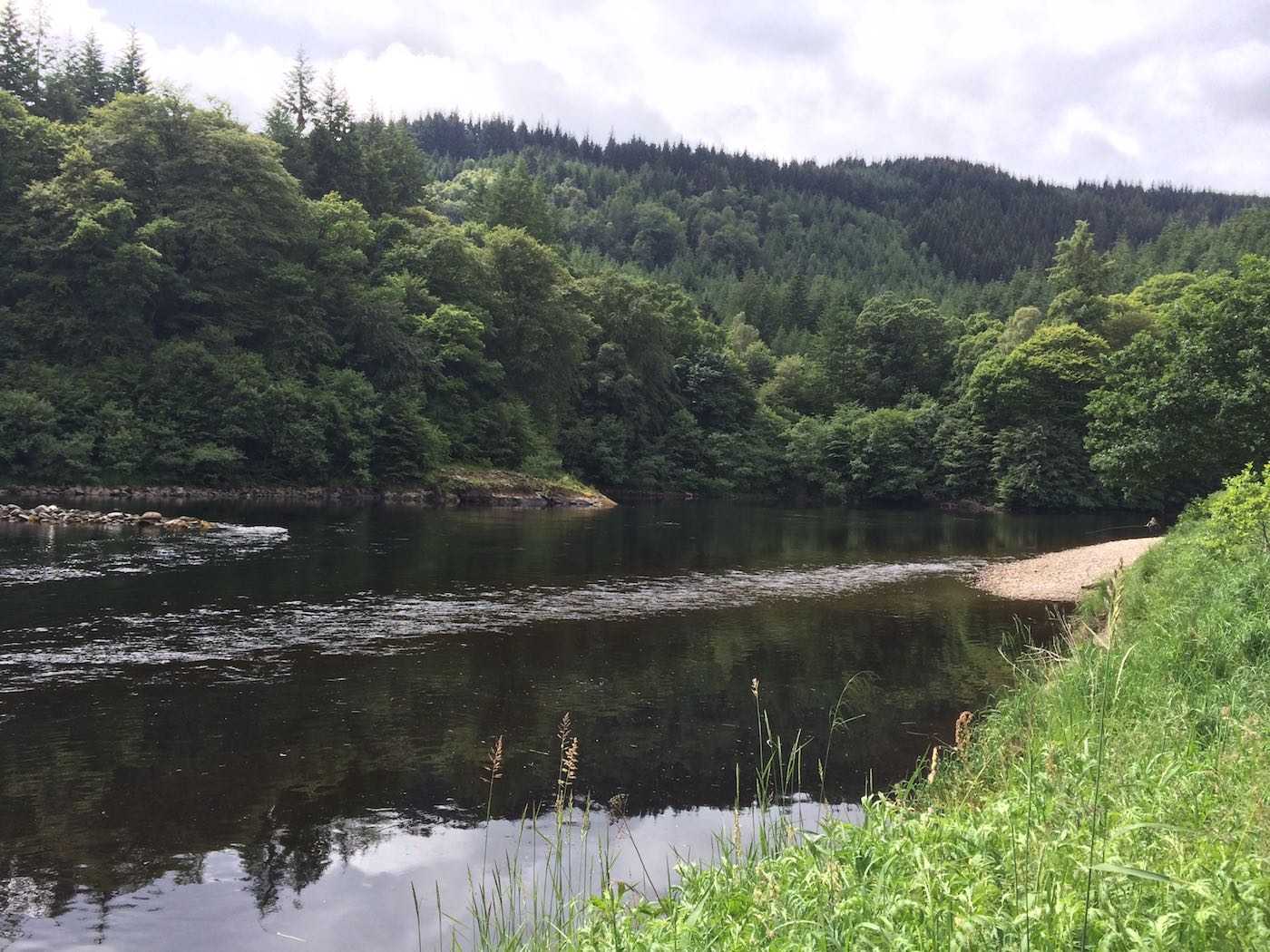This is a low water Summertime shot of the tail of the Rock Pool on the Dunkeld House salmon beat of the River Tay in Perthshire. Many salmon hold up in here when the river is running low as there's a deep channel over on the other side where you see that rocky point that experienced salmon fly fishers can cover with a long cast.