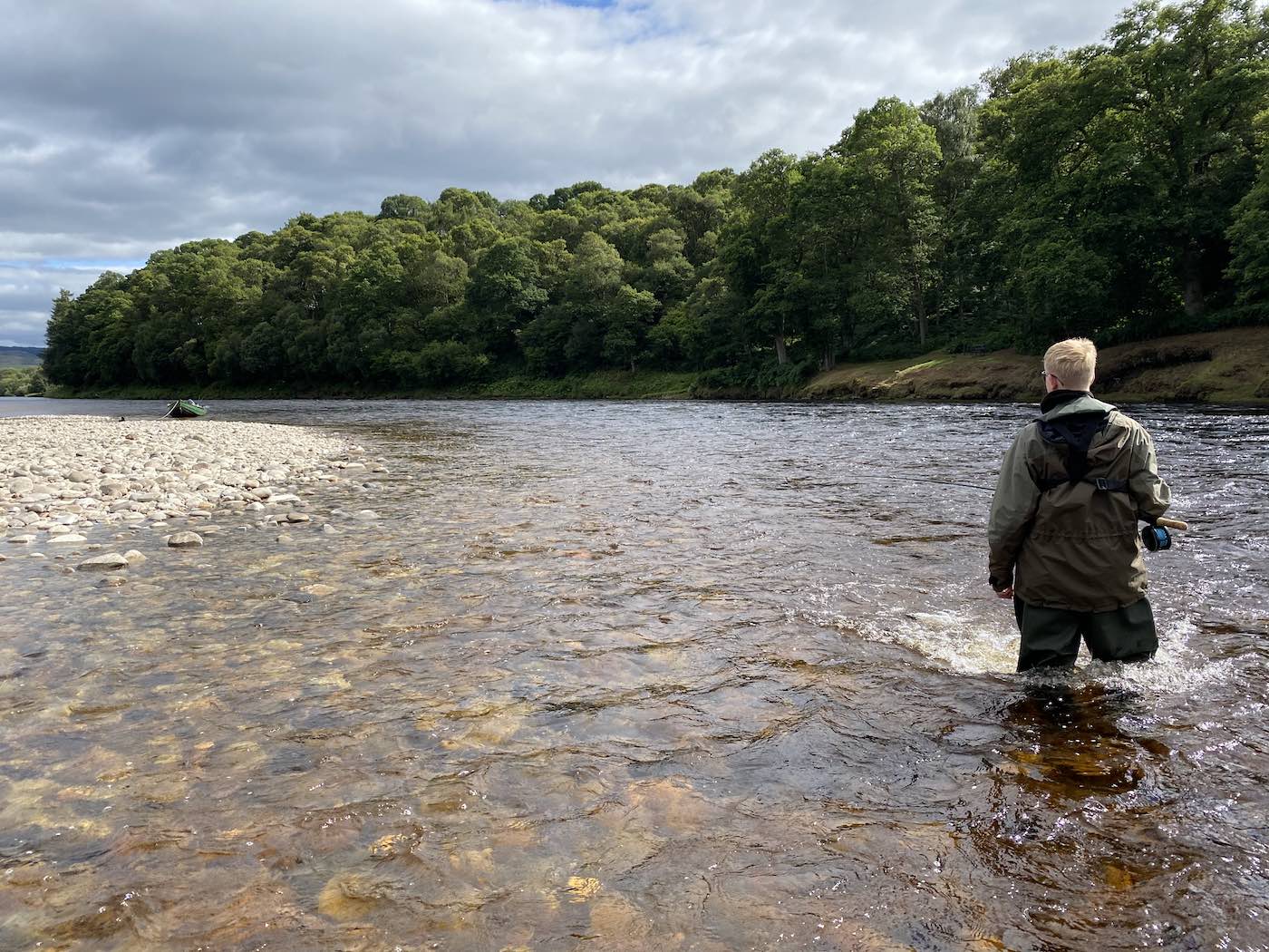 Here's a salmon fly fisher wading down through the mouth of the River Tummel where this river meets the River Tay. Technically he's wading too deep through this fast stream and if he came back in just a foot or two he'd reduce the water pressure significantly on the the back of his legs.