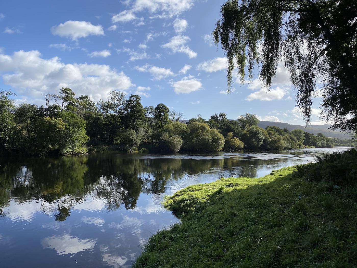 This beautiful shot of the River Tay was taken during Summertime on the River Tay between Pitlochry & Dunkeld which is a great area for salmon fly fishing. Imagine a day out in this amazing natural playground. This is the Green Bank pool of the Kinnaird Beat and where you see the riverbank grassy point is where a little gargling stream flows into the Tay.