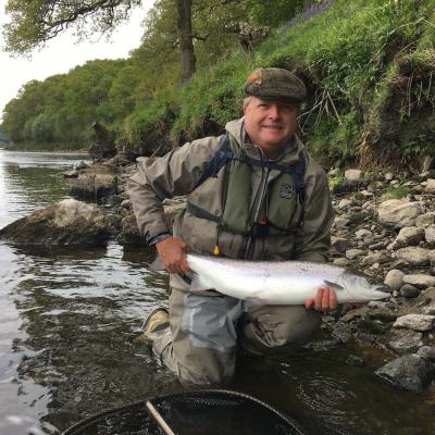 Here's a fresh run 'Springer' seconds before its safe release back to the River Tay. Look at the beautiful silver flanks on this fish. This regular Tay salmon fisher came all the way from Austria for this salmon fishing experience. Our salmon fishing guide service equips all fishing guests with all of the gear he is wearing plus an automatic life jacket too as you can see.