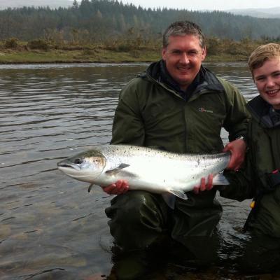 Here's professional River Tay salmon guide Jock Monteith with a brand new salmon fishing trip guest holding a heavyweight Spring salmon which was caught on the River Tay. This was the first of 2 heavyweight salmon caught by this young salmon fisher that morning,.