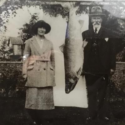 Georgina Ballantine's 64 lbs salmon from the Glendelvine Beat of the Tay was caught on the 7th of October 1922. This British record salmon was finally landed in the darkness downstream of the then old iron Caputh Bridge after and epic battle that lasted over an hour. The fish was hooked in the Boat Pool neck a few hundred yards upstream of the Caputh Bridge. The old Iron Caputh Bridge was dismantled 20+ years ago and now there's a slick new modern road bridge there. If you look over the upstream side of the new bridge you can still see the stanchion foundations of the old bridge on the riverbed.