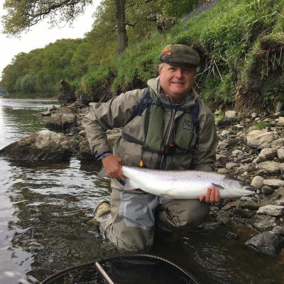 This salmon fishing tour guest keeps his lucky flies in his fishing cap as you can see here. Most of the old school Scottish salmon ghillies used to do the exact same thing. This perfect Spring salmon was caught on the River Tay near Pitlochry and I took this fine shot as his personal salmon fishing guide that day.