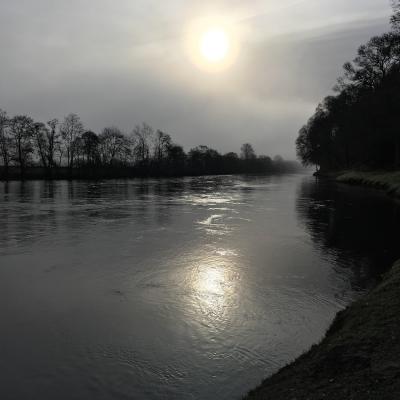 The rising sun looks huge above the River Tay in this fine early morning shot which was taken near Pitlochry on the River Tay. The ripple in the mid section of on the sunbeam are the sub surface stones that form the Daffodil Lie on the Kinnaird salmon Beat. As a professional salmon fishing guide I always reach for my camera when I see special light conditions like this.