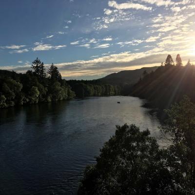 This upstream dusk shot of the Cathedral Stream was taken from the middle section of the Telford Bridge in Dunkeld. You can see the  salmon fishing guide with his fishing guest still out in the boat as the light is starting to fade in pursuit of an evening salmon.