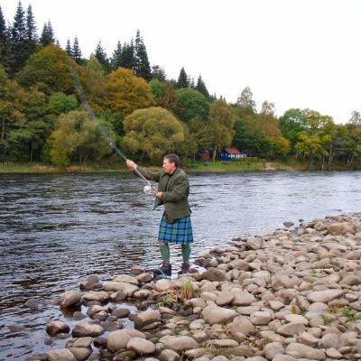 Here's professional salmon fishing guide Jock Monteith demonstrating the single Spey right hand up cast with his Graham of Menteith tartan kilt and lovat green Tweed jacket. The blue fishing hut across the river is the Newtyle Beat fishing hut near Dunkeld where Jock served as Head Ghillie for a decade. This shot was taken at the neck of the Newtyle Beat's Boil Pool.