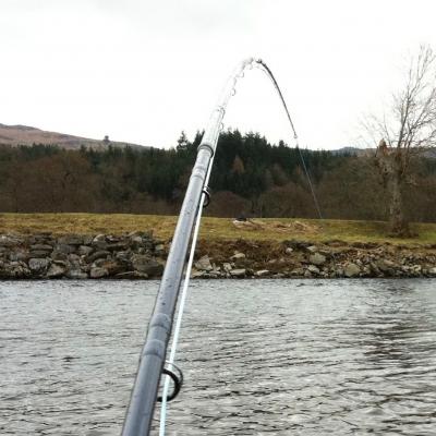 Tape your salmon fly rod joints tightly with pre-stretched electrical tape exactly centred between both joints like you can see here. 5 or 6 turns of taut tape will stop the rod twisting from loosening off the joints which if that happens could easily end up in rod joint damage. A good salmon fly rod will last a lifetime if this simple taping protocol is followed before every fishing outing. This shot was taken of me playing a salmon in the Guay Pool on the Lower Kinnaird salmon beat of the River Tay while I was working as a salmon fishing instructor.