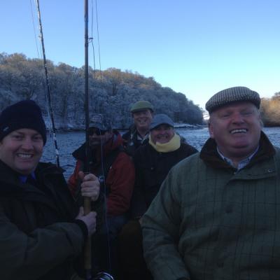 You can see the frozen riverbanks behind this group of celebrating River Tay salmon fishers. This was an opening day party out in the boat near Pitlochry. Early January is a highly picturesque time to be out salmon fishing as long as you wrap up well like these salmon fishers did.