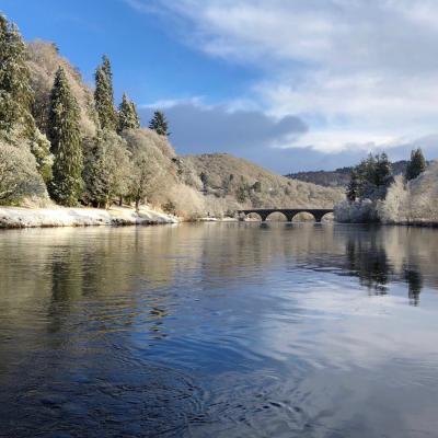 Here's a fine Winter shot of a downstream view of the River Tay taken by the River Tay boatman at Dunkeld. Note the historic 200 year old Telford Bridge in the distance which is one of the Tay's most famous sandstone bridges. This shot was taken during late January after some local snow fall.