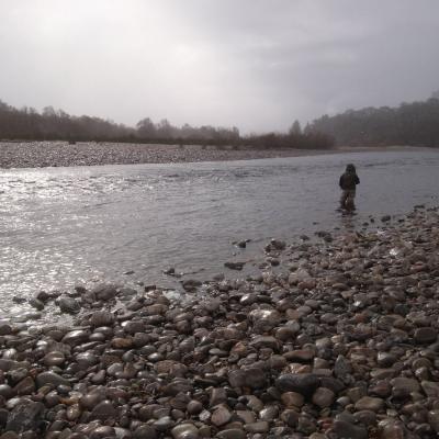 This salmon fishing holiday angler is fly fishing through the Mike's Run Pool of the River Tummel during a cold & wet early Spring day. I just had to grab this shot as his salmon guide when the sun appeared through the clouds as it was far too spectacular a light show moment to ignore.