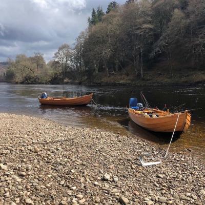 Here's a brace of these special larch & oak built River Tay salmon fishing boats. These boats are known as the 'Tay coble' and are fantastic for assisting guests to catch salmon. These have numerous fishing applications such as harling, trolling, anchored up fishing which can often provide a salmon fishing advantage. You can see the long rope and anchor in addition to the blue padded comfortable boat seats.