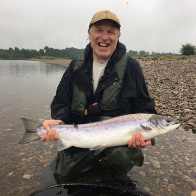This American salmon fisher was rewarded for his trans Atlantic crossing with this perfect River Tay Summer salmon which was landed just upstream of the village of Meikleour while I was assisting him as his personal salmon fishing guide. When I took this photograph the guest couldn't stop smiling due to the sheer excitement of the capture of this fine fish.