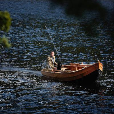 This Tay 'coble' boat was hand made by famous River Tay boatbuilder John Ferguson who's based in Stanley in the Tay Valley. These traditional salmon fishing boats serve many different fishing applications and are a pleasure to be out on the Tay in one for the day. This photograph of me in the boat with my fly rod & my labrador dog 'Selkie' was taken in the Cottar Pool on the Newtyle Beat of the River Tay by professional photographer Peter Sandground.