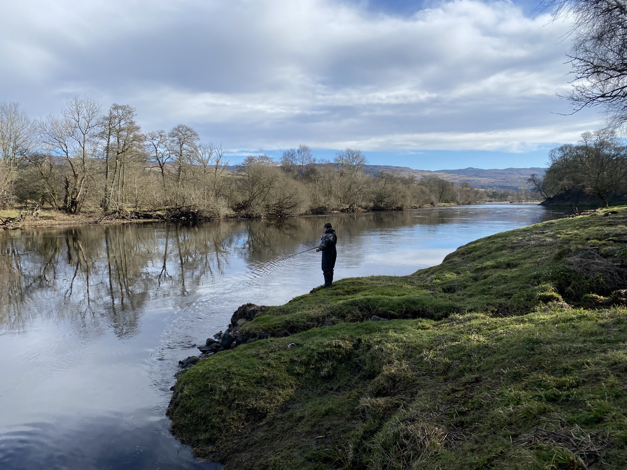 I took this shot of this salmon fishing guest spinning through the Green Bank pool on the River Tay near Pitlochry. You can see from the bare trees this shot was taken during early Spring. The spinner offers a salmon fisher the ability to cover much more water on a big river than what could realistically be achieved with a fly rod. This significantly increases the chance of a salmon take on big rivers like the River Tay in Perthshire but only if good riverbank cast spacings are added to the tactical spin approach.