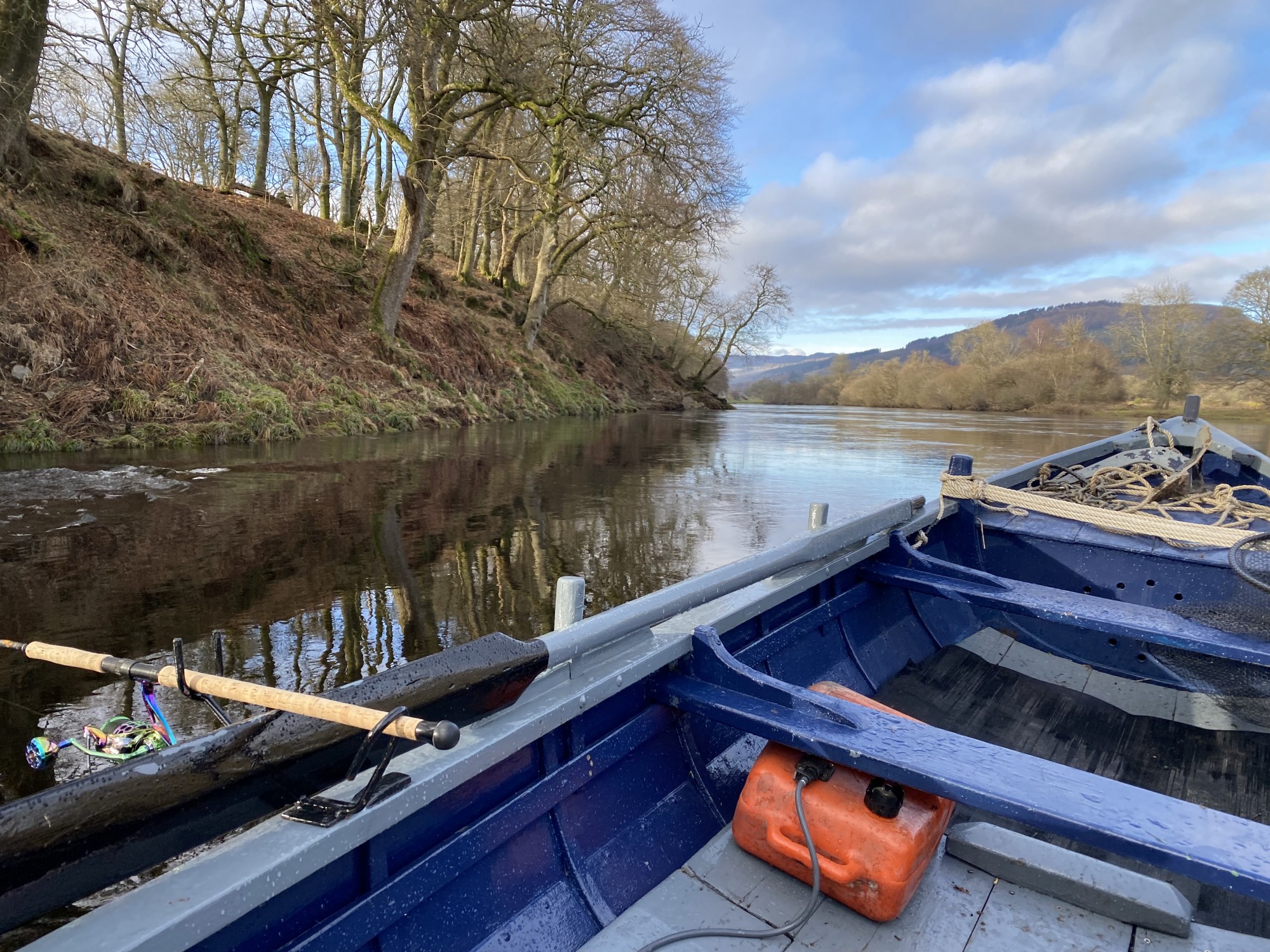 Here's a River Tay salmon boat out at the tail of the Kinnaird Beat's Rock Pool searching for a Spring salmon. You can see the rod firmly secured in the rod holder and the fuel can to feed the outboard engine. Many River Tay salmon fishing trip customers like this hands free method of fishing during the higher water levels of Spring.
