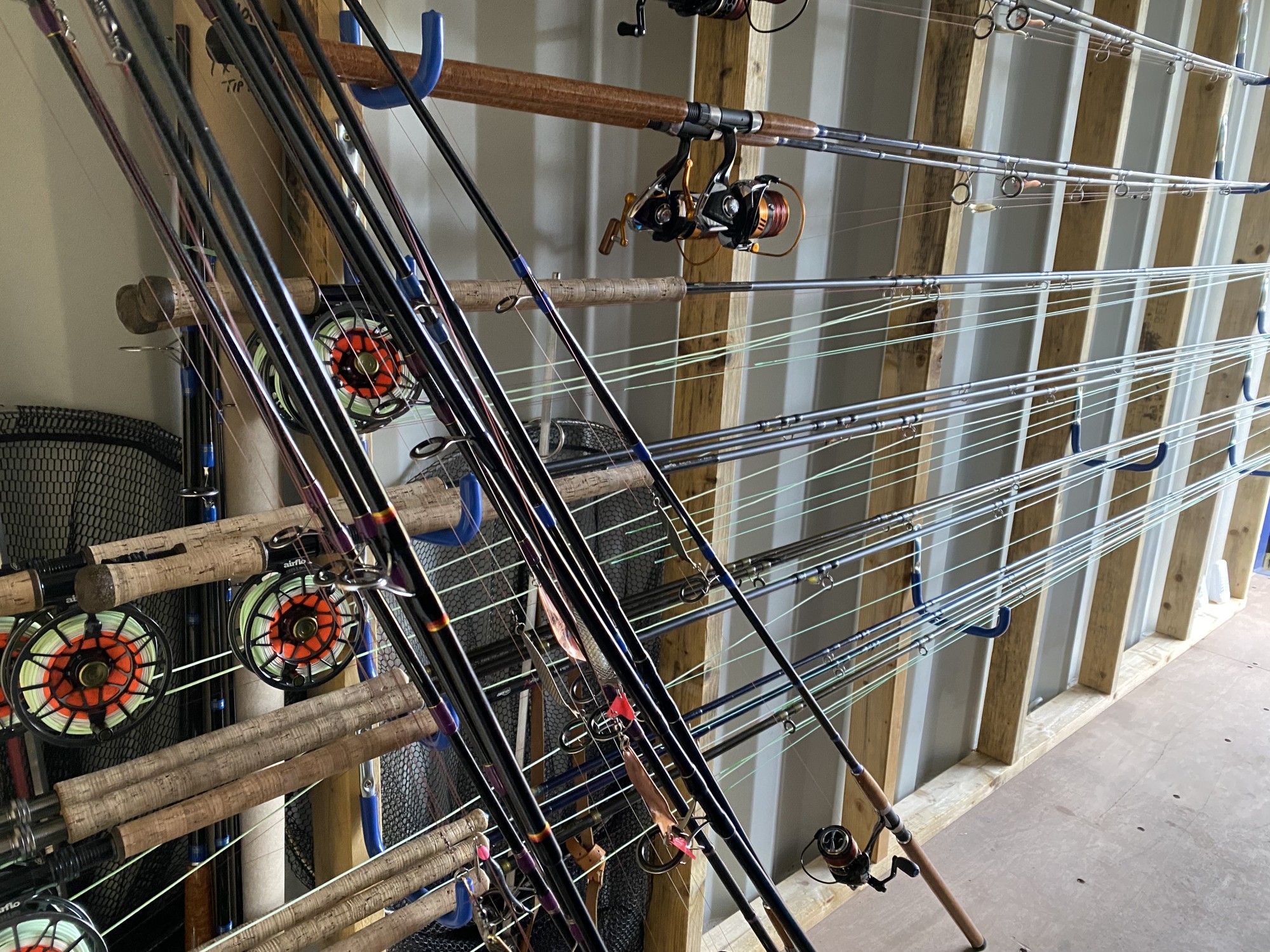 This is a small selection of the many salmon rods we keep for our salmon fishing guests on the River Tay. You can see both fly rods and spinning rods as both fishing methods work well on the Tay. This shipping container with these fitted wooden racks makes it easy to store these fully assembled rods for our River Tay salmon fishing clients.