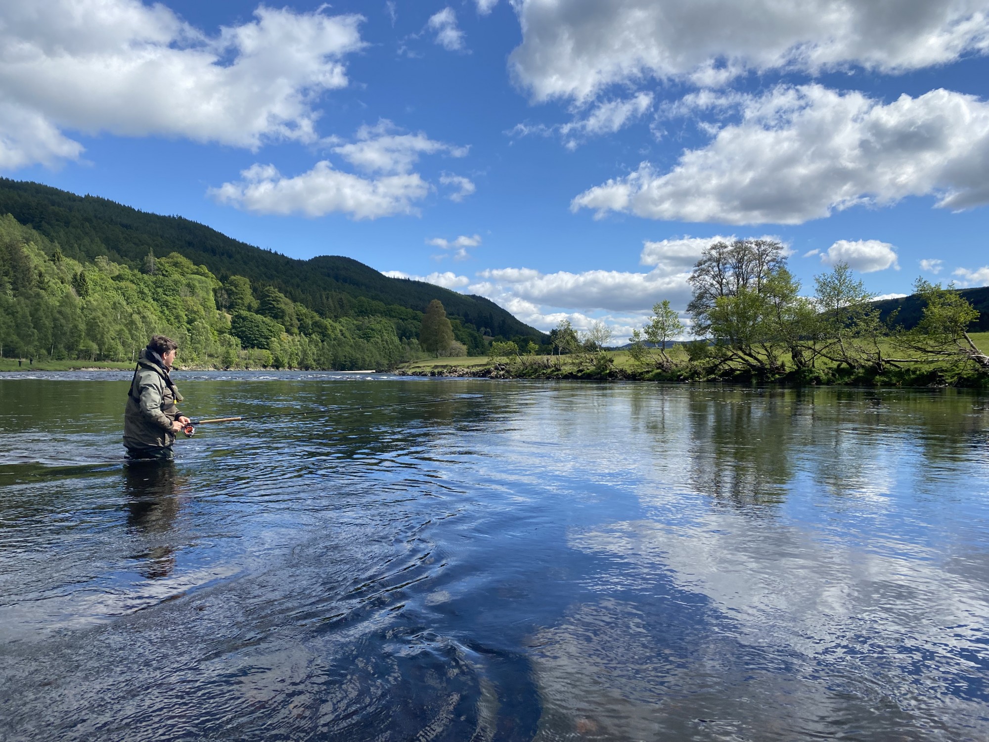 I took this shot of a salmon fishing trip guest on the River Tay slightly north of Dunkeld. This pool tail is a great salmon lie for running fish to stop and are often caught here. On the opposite riverbank where you see the bigger tree there's a deep water channel and that is exactly where salmon can often be located.