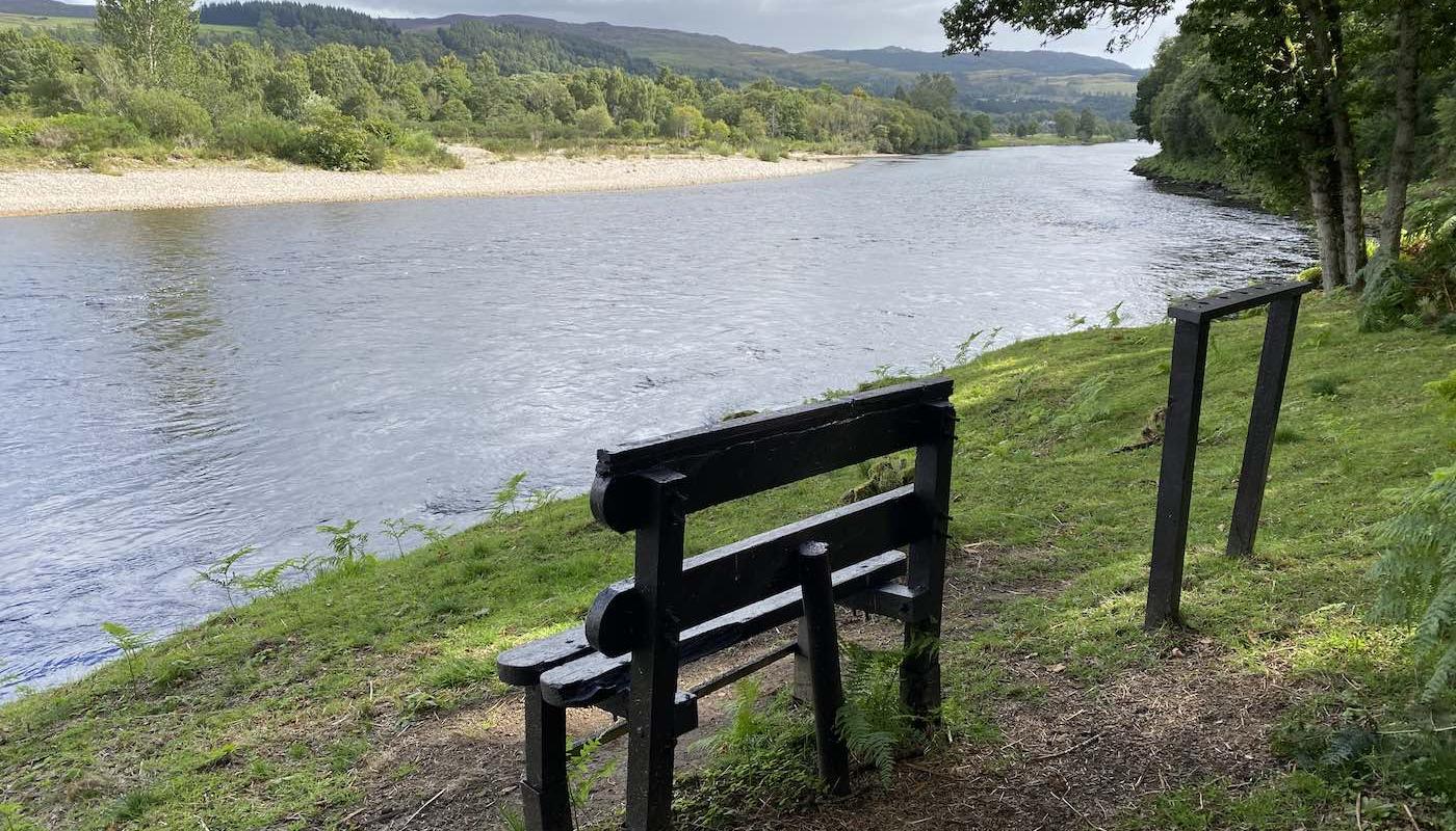 This old bench was found hanging from a riverbank tree 1 mile upstream of its now perfect location directly in front of the  River Tay & River Tummel confluence following an early Spring flood. As soon as I saw the bench and had salvaged it I knew exactly where it was going to be re-sited and its now been here in this perfect elevated riverside location for the last decade. This is the most perfect seat for observing one of the most beautiful areas or the entire River Tay from. I added the accompanying rod rest rack in too as you can see.